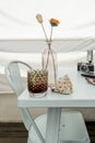 Relaxing image of a table on a penthouse terrace with a drink, a conch shell, a vase with flowers