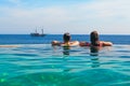 Relaxing in infinity swimming pool with sea view Royalty Free Stock Photo