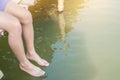 Relaxing for life, natural therapy concept : Young man people sitting relaxes to swing feets near water surface on side edge of