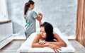 Relaxing massage on the foot in spa salon Royalty Free Stock Photo