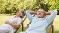 Relaxing mature couple sitting on sun loungers Royalty Free Stock Photo