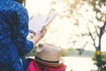 Relaxing moment Asian tourist reading a book on rock Royalty Free Stock Photo