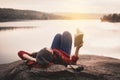 Relaxing moment Asian tourist reading a book on rock Royalty Free Stock Photo