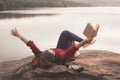 Relaxing moment Asian tourist reading a book on rock Royalty Free Stock Photo