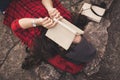 Relaxing moment Asian tourist reading a book on rock