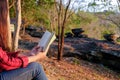 Relaxing moments, Young woman reading a book in nature background. Solo relaxation, color of Hipster Tone. Royalty Free Stock Photo