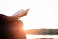 Relaxing moments, Young woman reading a book in nature background. Solo relaxation, color of Hipster Tone. Royalty Free Stock Photo