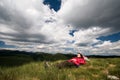 Relaxing on the mountain, under dramatic clouds Royalty Free Stock Photo