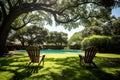 Relaxing outdoor lounge chairs with picturesque pool view in serene backyard setting Royalty Free Stock Photo