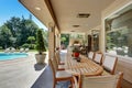 Relaxing outdoor seating arrangement overlooking swimming pool.