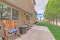 Relaxing patio with two wooden rocking chairs on a concrete slab