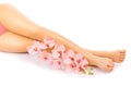 Relaxing pedicure with a pink orchid flower Royalty Free Stock Photo