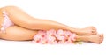 Relaxing pedicure with a pink orchid flower Royalty Free Stock Photo