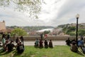 Relaxing people on hill over river Douro, with friends and nice view cityscape