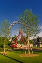 Relaxing people and observation wheel at the park in the historical downtown of Geneva, Switzerland, summer