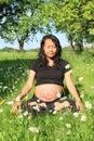 Relaxing pregnant woman with drawn baby exercising yoga