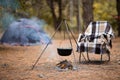 Relaxing and preparing food on campfire in camping, autumn rest in forest