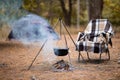 Relaxing and preparing food on campfire in camping, autumn rest outdoors