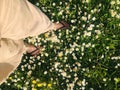 Relaxing relaxation peace of mind peaceful moment in nature concept. Young woman walking on green grass and daisy flowers. Relaxin Royalty Free Stock Photo