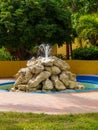 Relaxing resort water fountain made from large boulders Royalty Free Stock Photo