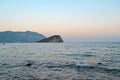 Relaxing seascape in Budva, Montenegro. Lonely island on horison under sunset clear sky. Time for travel, tourism, relax, leisure Royalty Free Stock Photo