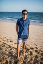 Relaxing and smiling asian young man on the beach Royalty Free Stock Photo