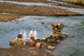 Relaxing Soak in Nature: Two Women Enjoying Reykjadalur Hot Spring Thermal River, Iceland Royalty Free Stock Photo