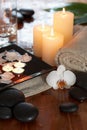 Relaxing spa with candles orchids towels and stone Royalty Free Stock Photo