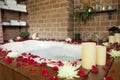 Relaxing spa with rose petals and bubble bath Royalty Free Stock Photo