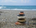 Relaxing in the summer concept. Stones stacked on the beach on sea background