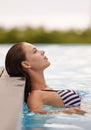 Relaxing summer vacation. a woman relaxing in a swimming pool. Royalty Free Stock Photo