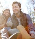 Relaxing together. A happy young couple sitting together outdoors in the woods. Royalty Free Stock Photo