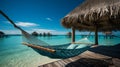 Relaxing tropical island getaway. hammock between palm trees by the crystal blue sea Royalty Free Stock Photo