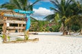 Relaxing tropical seaside resort, white sand beach, palm trees, diving padi courses sign