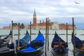 View of the Venice lagoon with gondolas tied to poles