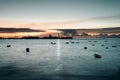 Relaxing view of small boats in the sea on a sunset sky background Royalty Free Stock Photo