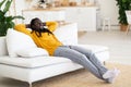 Relaxing Weekend. Smiling Young African American Man Resting On Couch At Home Royalty Free Stock Photo