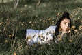 Relaxing woman lying on spring blooming meadow. Girl resting in spring park. Enjoy life Royalty Free Stock Photo