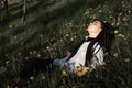 Relaxing woman lying on spring blooming meadow. Girl resting in spring park. Royalty Free Stock Photo