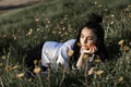 Relaxing woman lying on spring blooming meadow. Girl resting in spring park. Royalty Free Stock Photo