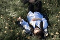 Relaxing woman lying on spring blooming meadow. Girl resting in spring park. Enjoy life Royalty Free Stock Photo