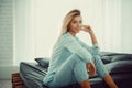 Gorgeous woman sitting on a sofa in her living room Royalty Free Stock Photo