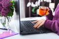 Relaxing woman working or learning from home using laptop drink tea. Freelancer have remote work, online education, work on Royalty Free Stock Photo