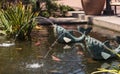 Relaxing zen fountain in a koi pond Royalty Free Stock Photo