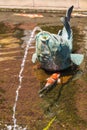 Relaxing zen fountain in a koi pond Royalty Free Stock Photo