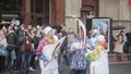 Relay race Sochi Olympic torch in Saint Petersburg. Aged female pass flame to man. Torchbearers