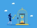 Release the freedom of time. Value of time. Businesswoman uses key to release clock from birdcage