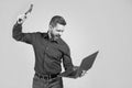 Releasing anger on computer. Stressed man yelling and breaking laptop with hammer. Got stressed Royalty Free Stock Photo