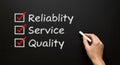 Reliability service quality checklist with check marks on black board Royalty Free Stock Photo