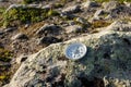 Reliable compass on the stone in tundra. Concept for travelling and active lifestyle